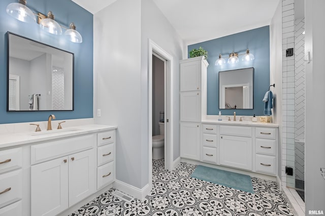 1100 Wild W Dr, Le Claire, IA 52753 - full bath with two vanities, tile patterned flooring, and tiled shower