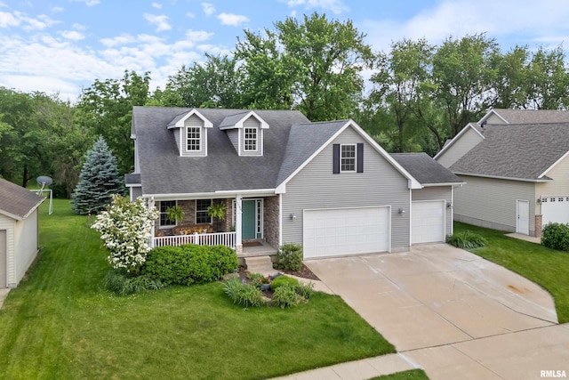 1100 Wild W Dr, Le Claire, IA 52753 - view of front of house featuring a porch, a front yard, concrete driveway, an attached garage, and stone siding