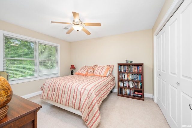 1100 Wild W Dr, Le Claire, IA 52753 - bedroom with a closet, light colored carpet, and ceiling fan