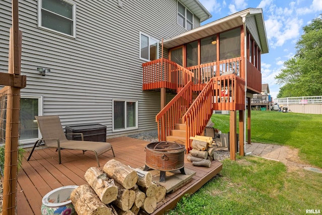 1100 Wild W Dr, Le Claire, IA 52753 - wooden terrace featuring a sunroom, an outdoor fire pit, a lawn, and stairs