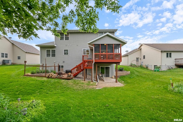 1100 Wild W Dr, Le Claire, IA 52753 - rear view of house featuring a sunroom, a wooden deck, a lawn, and a patio
