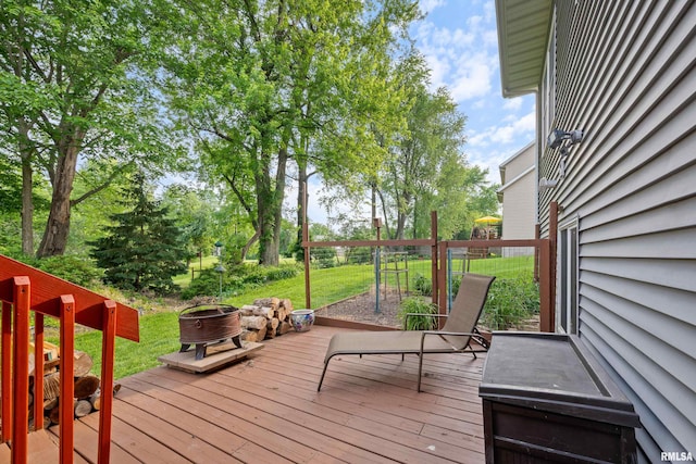 1100 Wild W Dr, Le Claire, IA 52753 - deck featuring a fire pit and a yard