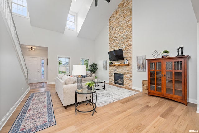 1100 Wild W Dr, Le Claire, IA 52753 - living area with a high ceiling, wood finished floors, a fireplace, and ceiling fan