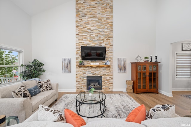 1100 Wild W Dr, Le Claire, IA 52753 - living room with high vaulted ceiling, a stone fireplace, and wood finished floors