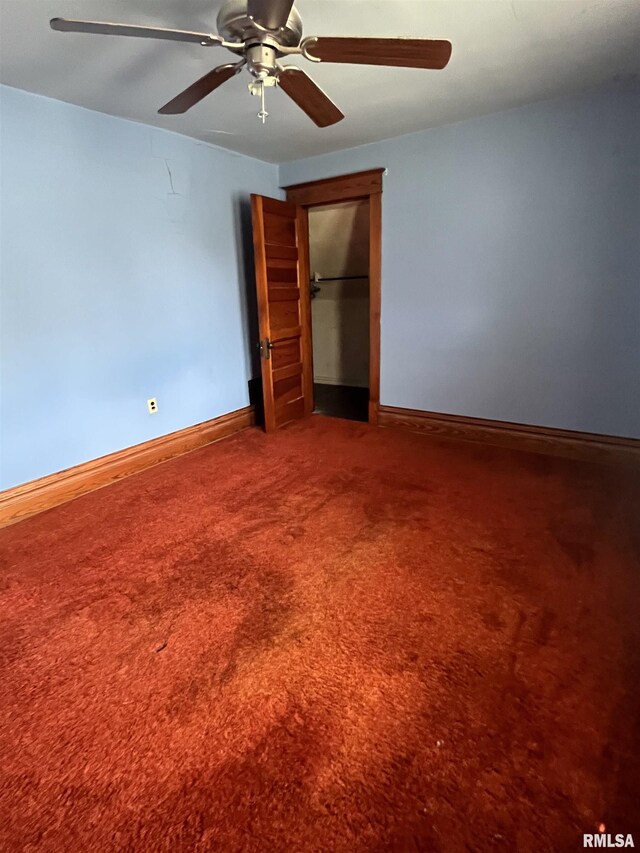 1109 S Michigan St, Davenport, IA 52802 - unfurnished bedroom with baseboards, carpet floors, and a ceiling fan