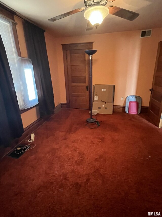 1109 S Michigan St, Davenport, IA 52802 - spare room featuring ceiling fan, carpet floors, and baseboards
