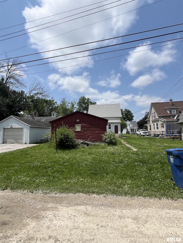 1109 S Michigan St, Davenport, IA 52802 - view of front of home with a garage, a front lawn, and an outdoor structure