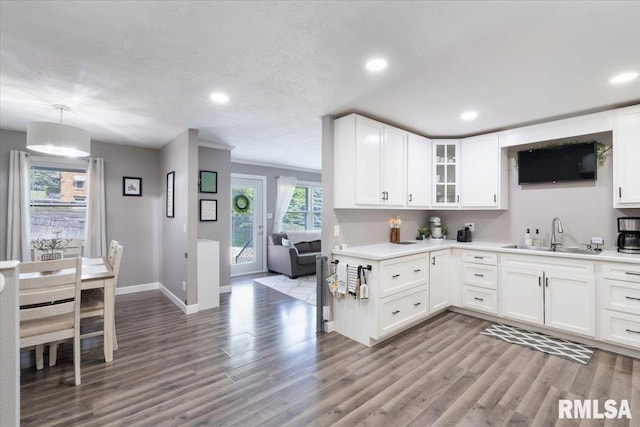 306 Myra Pl, Clinton, IA 52732 - kitchen featuring a sink, wood finished floors, baseboards, light countertops, and recessed lighting
