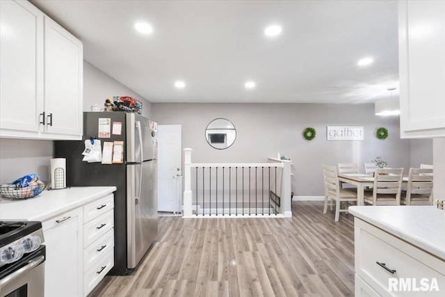 306 Myra Pl, Clinton, IA 52732 - kitchen featuring appliances with stainless steel finishes, white cabinets, light countertops, light wood-type flooring, and recessed lighting