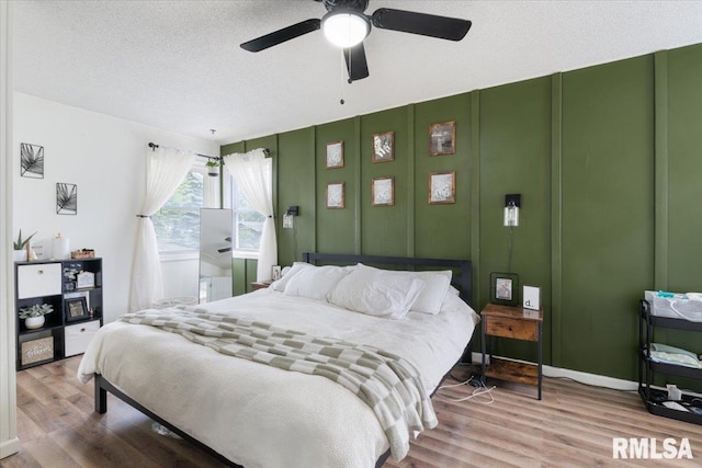 306 Myra Pl, Clinton, IA 52732 - bedroom with wood finished floors, ceiling fan, and a textured ceiling