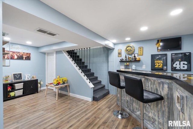 306 Myra Pl, Clinton, IA 52732 - indoor bar featuring stairs, wood finished floors, recessed lighting, and baseboards