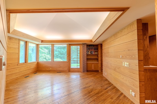 7 Sharon Ln, Fulton, IL 61252 - spare room featuring plenty of natural light, a tray ceiling, wooden walls, and wood-type flooring
