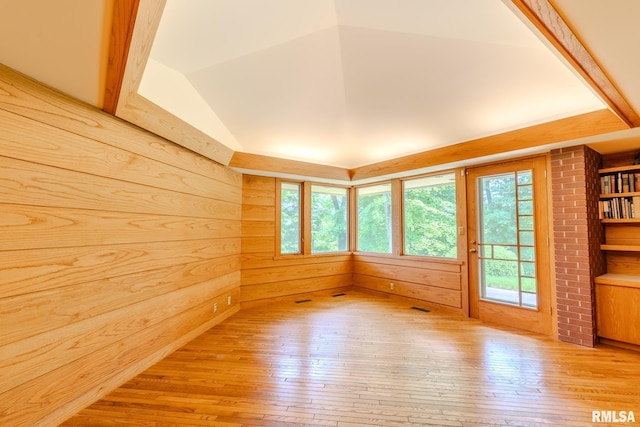 7 Sharon Ln, Fulton, IL 61252 - unfurnished room with light wood-type flooring, lofted ceiling, and wooden walls