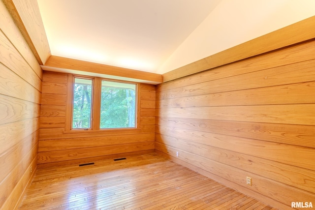 7 Sharon Ln, Fulton, IL 61252 - empty room with wood walls, light wood finished floors, and lofted ceiling