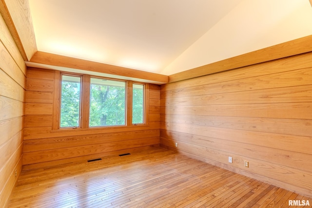 7 Sharon Ln, Fulton, IL 61252 - spare room featuring lofted ceiling, hardwood / wood-style floors, and wooden walls
