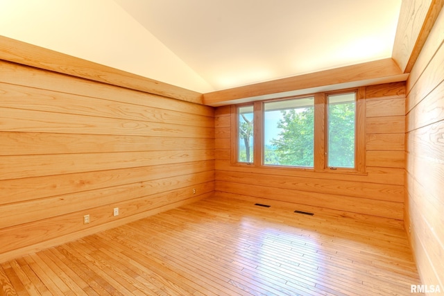 7 Sharon Ln, Fulton, IL 61252 - spare room with vaulted ceiling, wood walls, and wood-type flooring