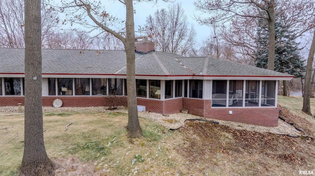 7 Sharon Ln, Fulton, IL 61252 - rear view of property with brick siding, roof with shingles, a sunroom, and a lawn