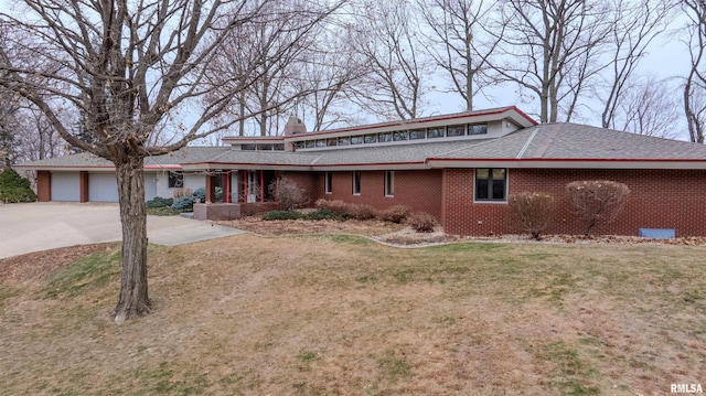 7 Sharon Ln, Fulton, IL 61252 - view of front of property with a garage, a front lawn, a chimney, brick siding, and concrete driveway