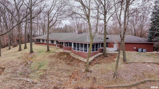 7 Sharon Ln, Fulton, IL 61252 - back of house with a sunroom, a shingled roof, and central AC unit