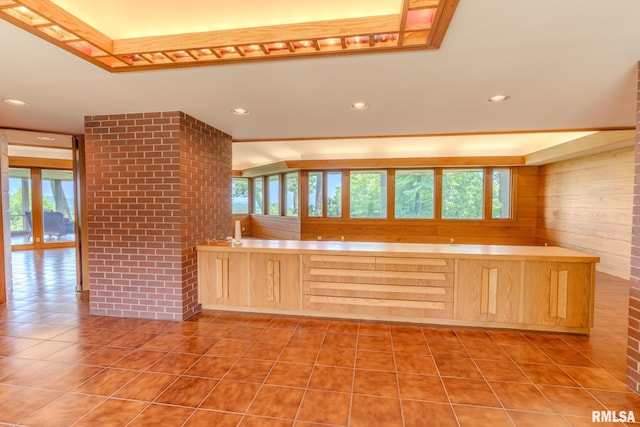 7 Sharon Ln, Fulton, IL 61252 - kitchen featuring light brown cabinets, plenty of natural light, light tile patterned floors, recessed lighting, and wooden walls