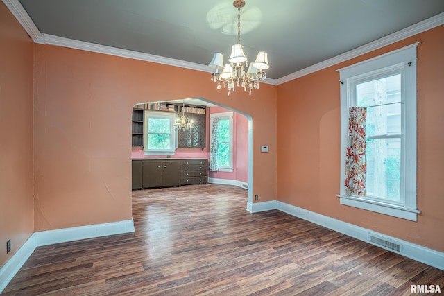 1032 Kirkwood Blvd, Davenport, IA 52803 - unfurnished dining area with a chandelier, wood finished floors, crown molding, and arched walkways