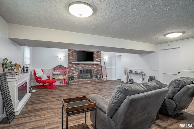 3436 Ridge Ct, Davenport, IA 52806 - living area featuring a brick fireplace, wood finished floors, a textured ceiling, and wainscoting