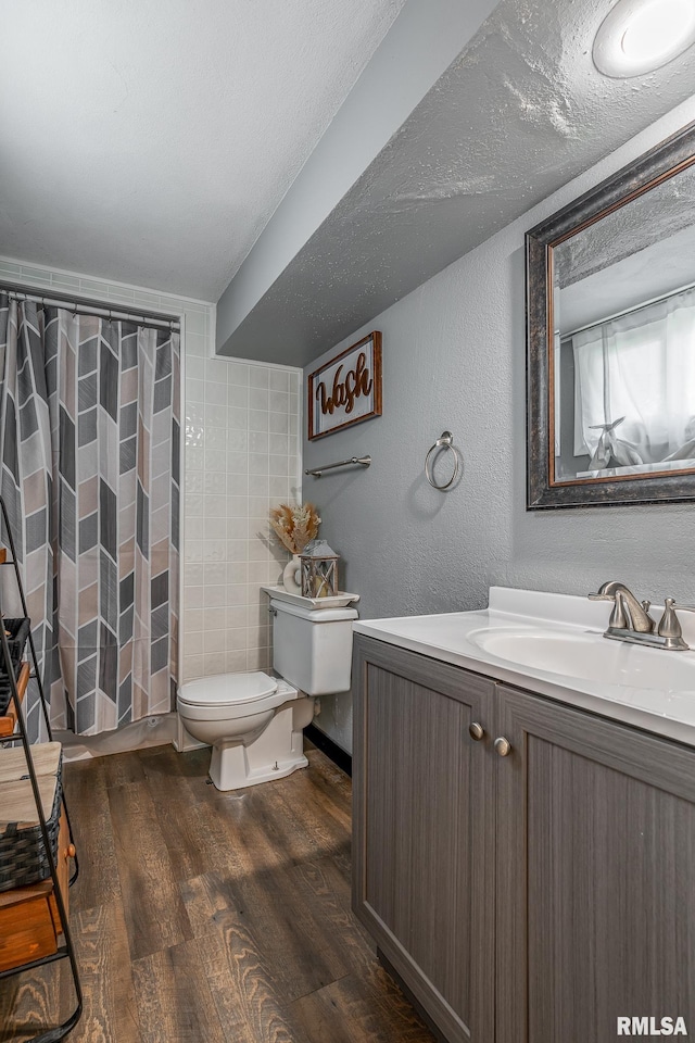 3436 Ridge Ct, Davenport, IA 52806 - bathroom with vanity, wood finished floors, a textured wall, and a shower with shower curtain