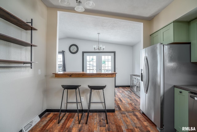3436 Ridge Ct, Davenport, IA 52806 - kitchen with green cabinetry, stainless steel appliances, dark wood-style floors, vaulted ceiling, and a chandelier