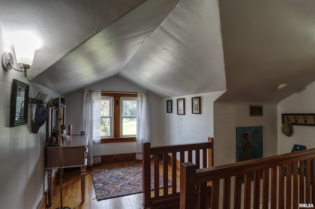 115 4th St, Fulton, IL 61252 - hallway featuring vaulted ceiling, wood-type flooring, and an upstairs landing