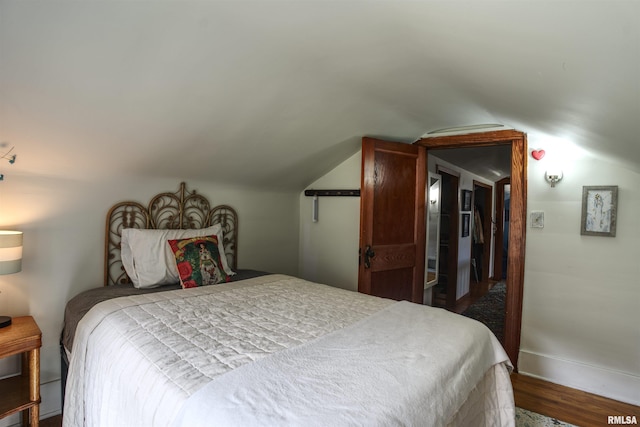 115 4th St, Fulton, IL 61252 - bedroom featuring vaulted ceiling and wood finished floors