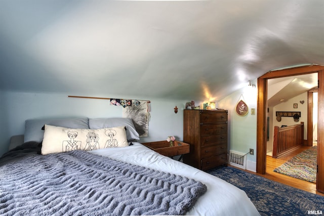115 4th St, Fulton, IL 61252 - bedroom featuring vaulted ceiling and wood finished floors