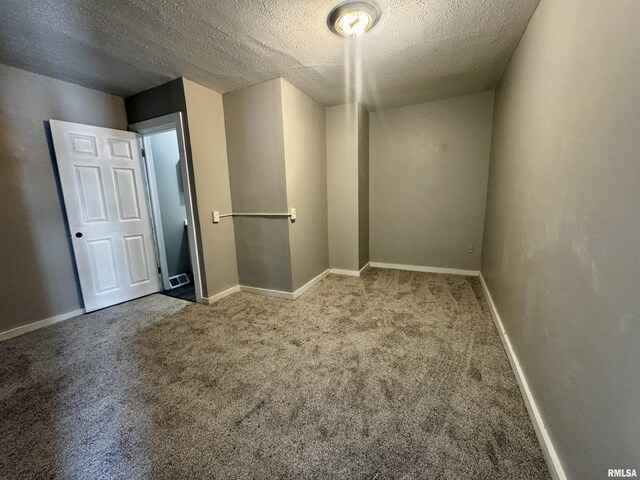 1150 14th Ave, Moline, IL 61265 - carpeted empty room with a textured ceiling and baseboards