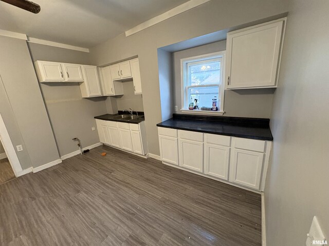 1150 14th Ave, Moline, IL 61265 - kitchen with dark wood-type flooring, white cabinets, and dark countertops