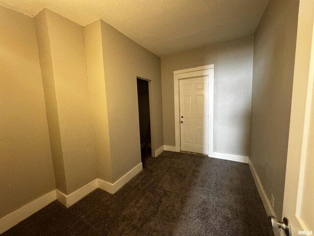 1150 14th Ave, Moline, IL 61265 - spare room with dark carpet and a textured ceiling