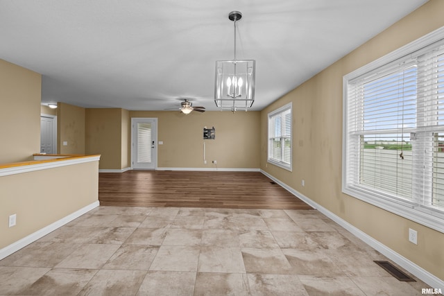 6365 Friendship Path, Bettendorf, IA 52722 - unfurnished dining area featuring a chandelier and ceiling fan