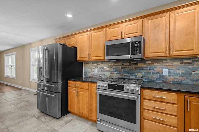 6365 Friendship Path, Bettendorf, IA 52722 - kitchen featuring stainless steel appliances, decorative backsplash, dark stone countertops, and recessed lighting