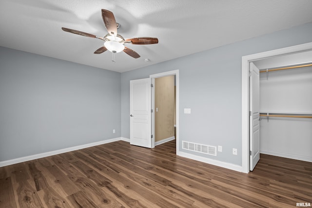 6365 Friendship Path, Bettendorf, IA 52722 - unfurnished bedroom with wood finished floors, a closet, a ceiling fan, and a spacious closet