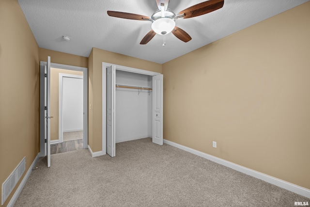 6365 Friendship Path, Bettendorf, IA 52722 - unfurnished bedroom with light colored carpet, a closet, a ceiling fan, and a textured ceiling