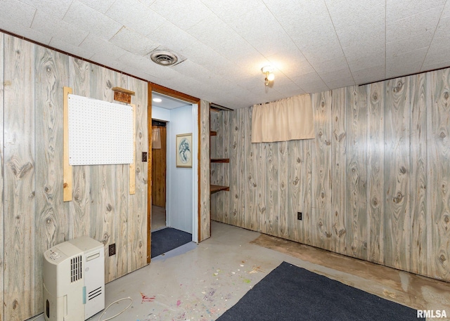 2678 170th Ave, Sherrard, IL 61281 - empty room featuring wooden walls and unfinished concrete floors