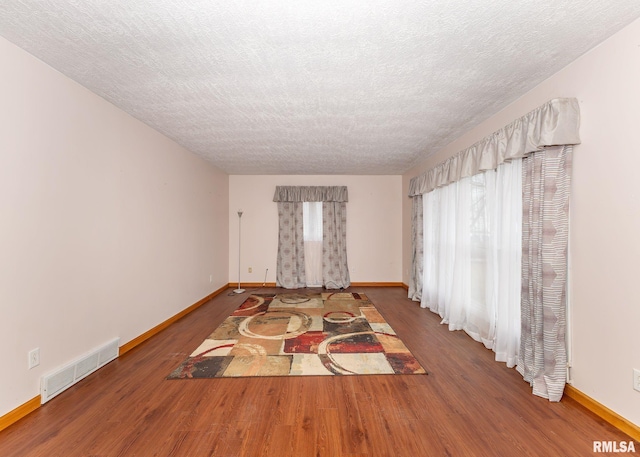 2678 170th Ave, Sherrard, IL 61281 - empty room with a textured ceiling and wood finished floors