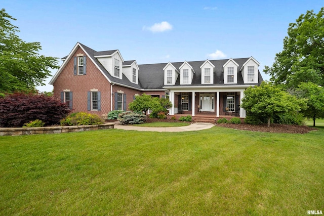 5 High Point Pl, Bettendorf, IA 52722 - new england style home featuring a porch, brick siding, and a front yard