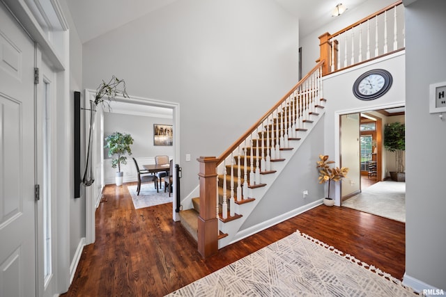 5 High Point Pl, Bettendorf, IA 52722 - entryway featuring high vaulted ceiling, stairway, and wood finished floors