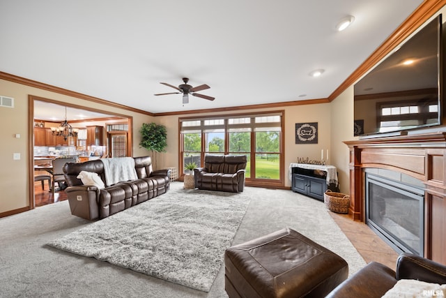 5 High Point Pl, Bettendorf, IA 52722 - living room featuring light carpet, ceiling fan, a glass covered fireplace, ornamental molding, and a chandelier