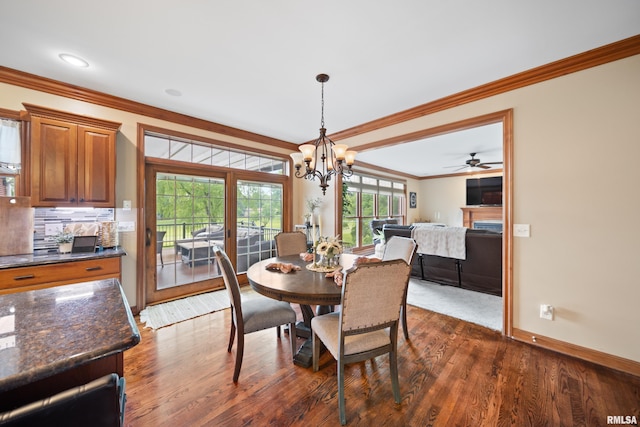 5 High Point Pl, Bettendorf, IA 52722 - dining area featuring crown molding, a chandelier, dark wood finished floors, and ceiling fan