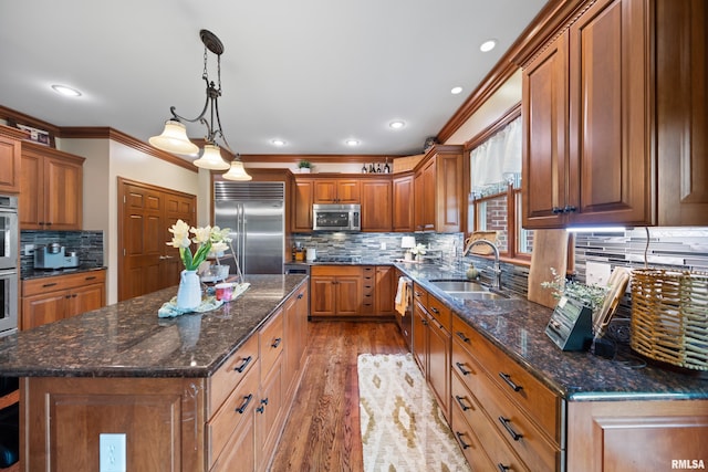 5 High Point Pl, Bettendorf, IA 52722 - kitchen with stainless steel appliances, ornamental molding, brown cabinets, decorative backsplash, and light wood-style floors