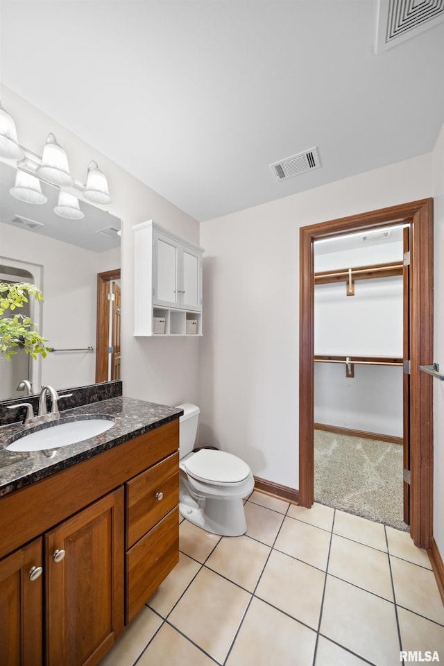 5 High Point Pl, Bettendorf, IA 52722 - bathroom featuring vanity, tile patterned flooring, and a walk in closet