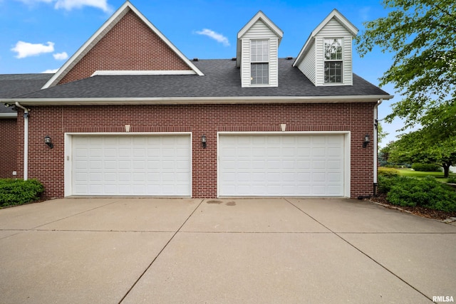 5 High Point Pl, Bettendorf, IA 52722 - view of side of home featuring brick siding, a shingled roof, driveway, and a garage
