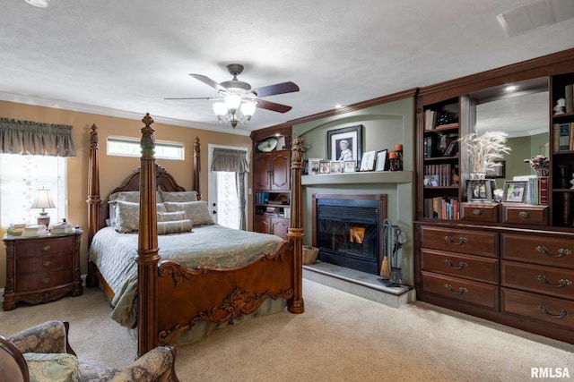 1300 W Brewster Rd, Herrin, IL 62948 - bedroom with ornamental molding, a glass covered fireplace, light colored carpet, and ceiling fan