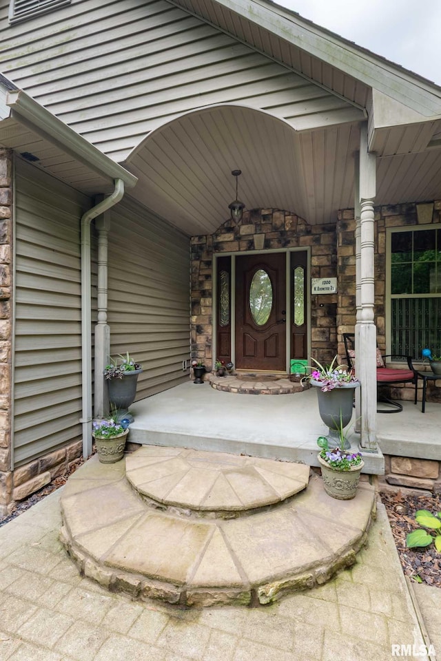 1300 W Brewster Rd, Herrin, IL 62948 - view of exterior entry featuring a porch and stone siding