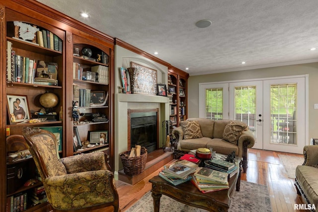 1300 W Brewster Rd, Herrin, IL 62948 - living area with a glass covered fireplace, ornamental molding, a textured ceiling, wood finished floors, and recessed lighting